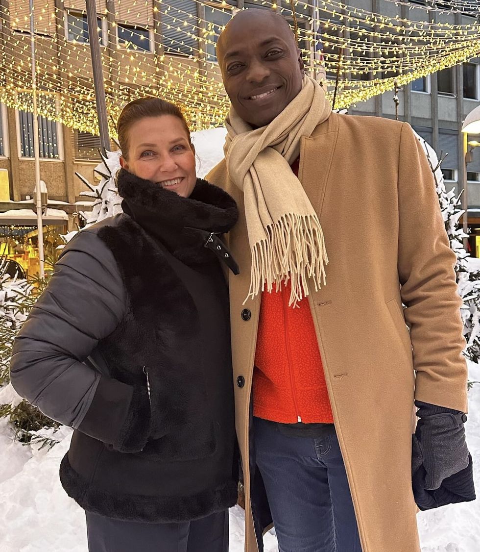 a man and woman posing for a picture in the snow