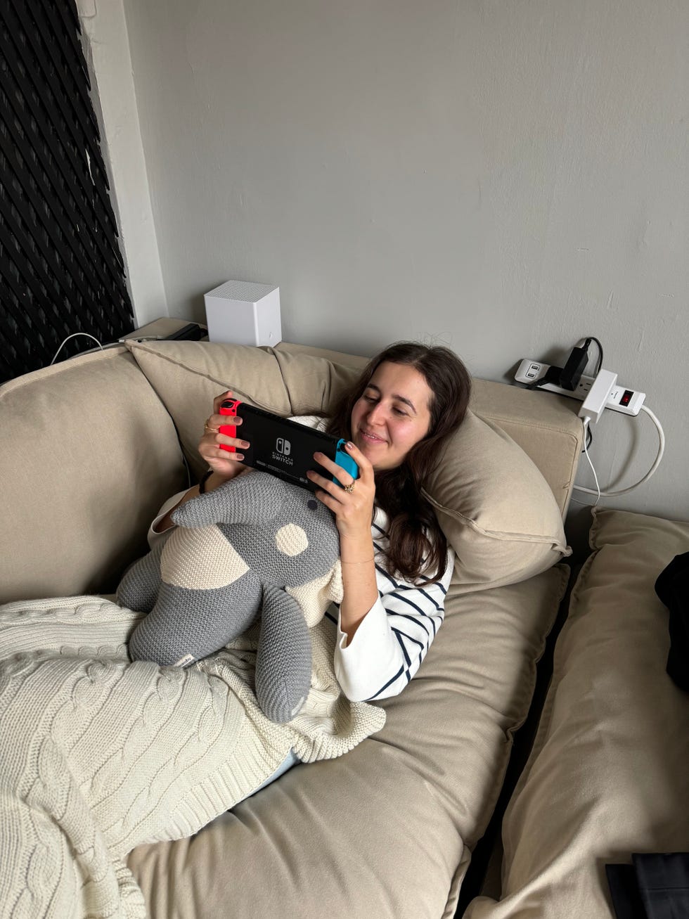 person playing video games while lounging on an albany park kova sofa, good housekeeping's albany park kova review
