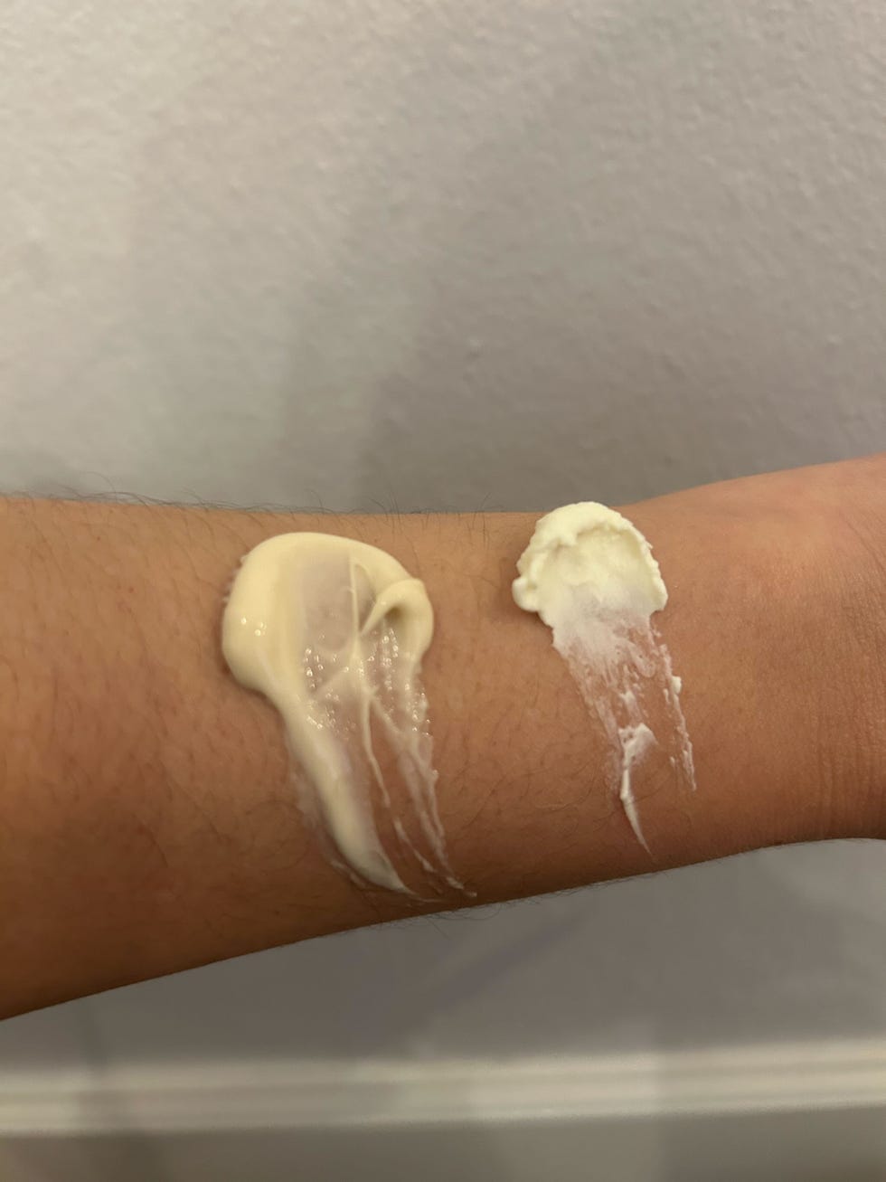 a hand holding a tub of brazilian bum bum cream