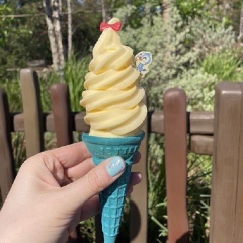 snow white ice cream cone in a hand at magic kingdom