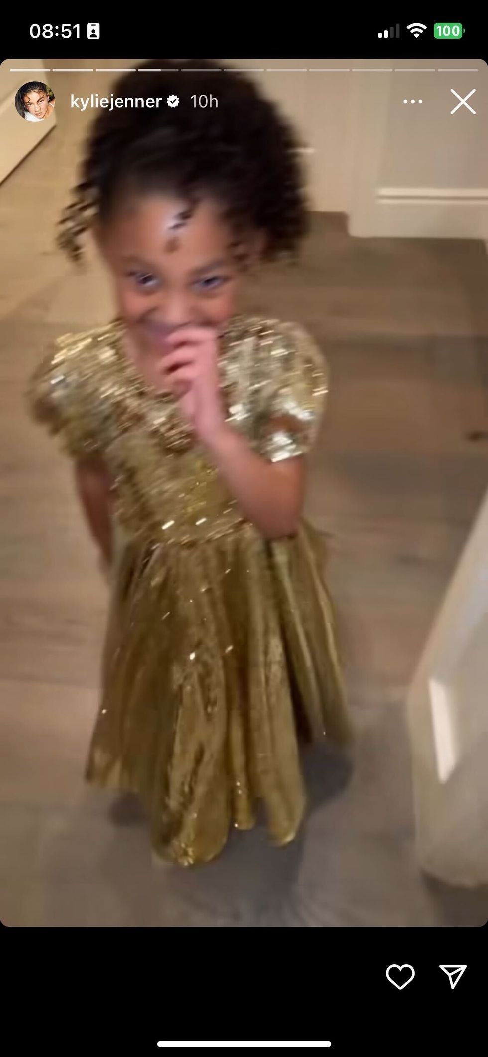 a child wearing a gold dress