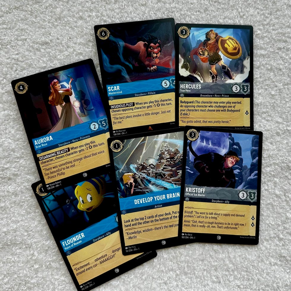 Disney Lorcana The First Chapter cards six disney lorcana trading cards, part of a good housekeeping story on the best card games