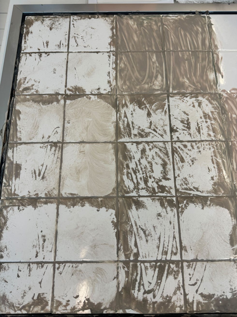 tile board with clay mask that's been scrubbed off