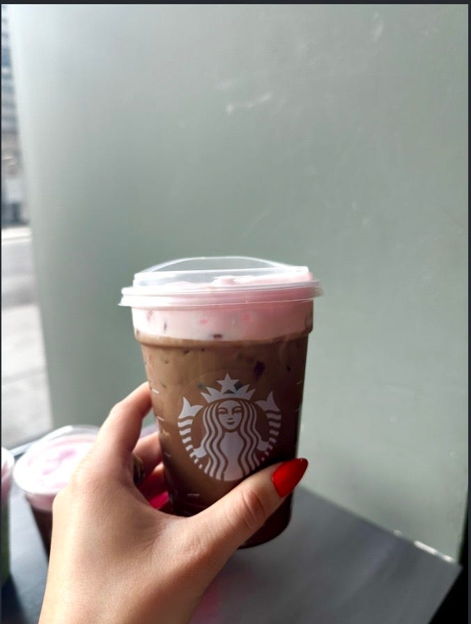 iced beverage from a popular coffee chain with a pink whipped topping