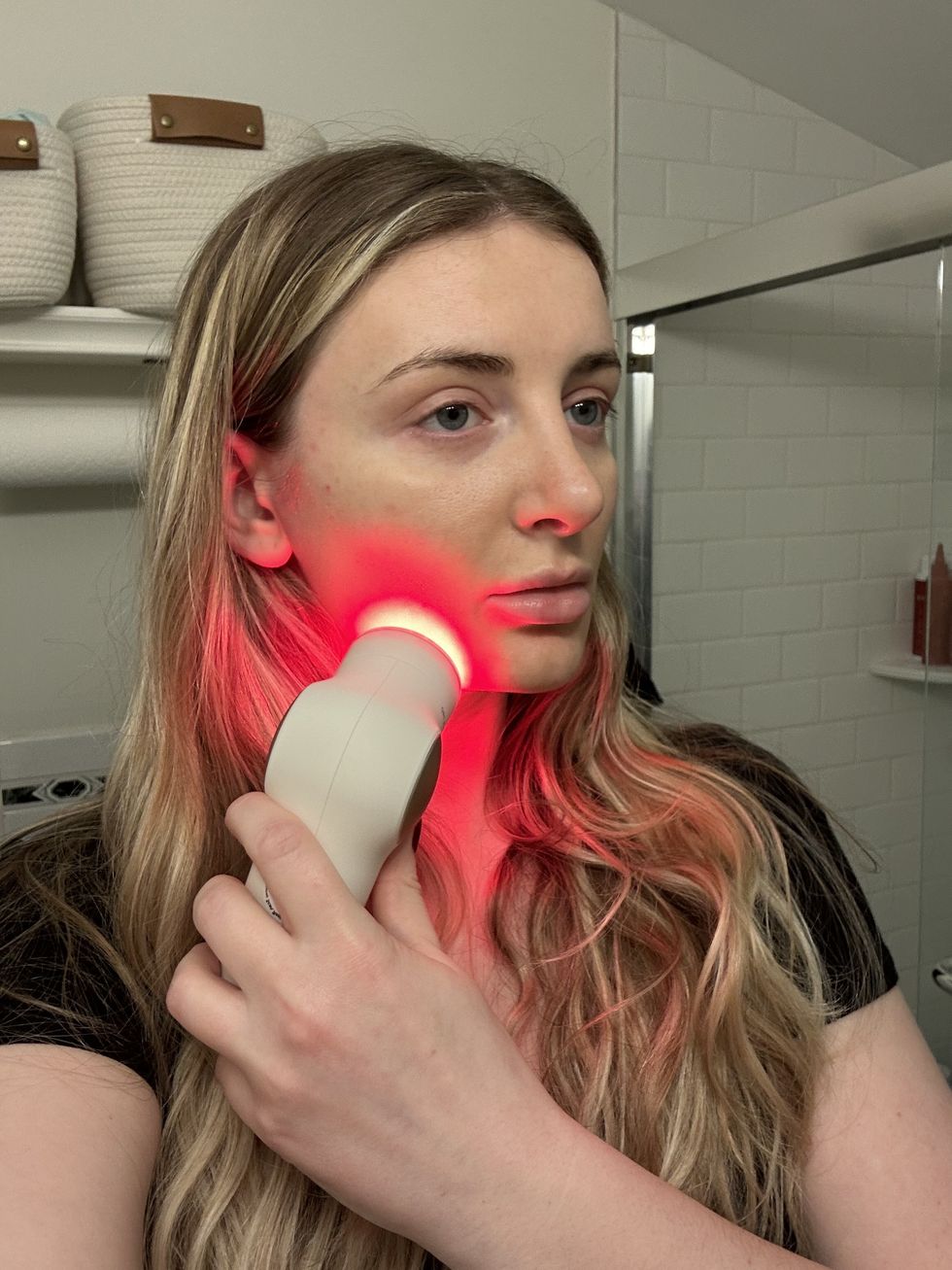 a woman using red led on theraface pro