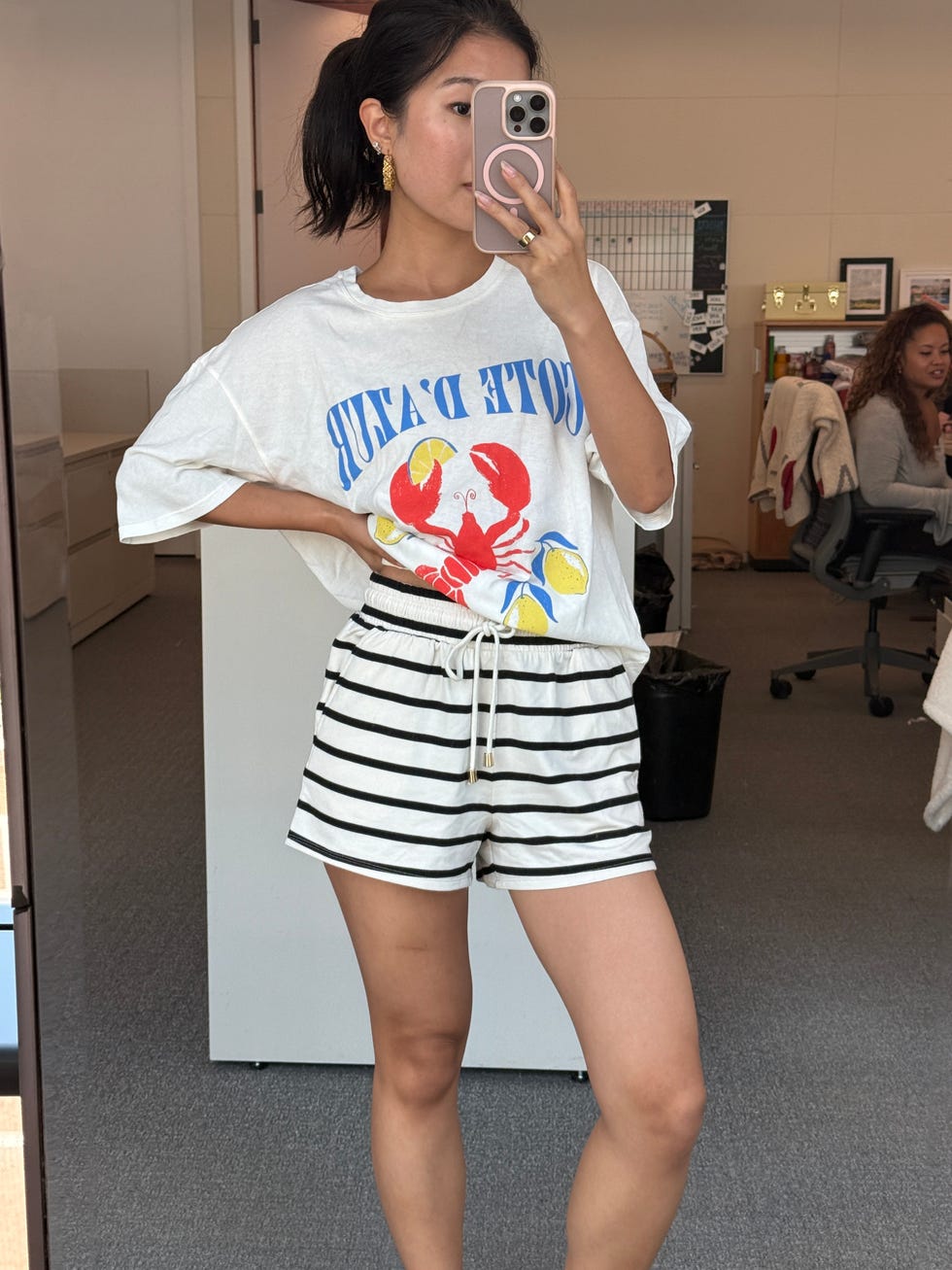 casual outfit featuring a lobster graphic tee and striped shorts