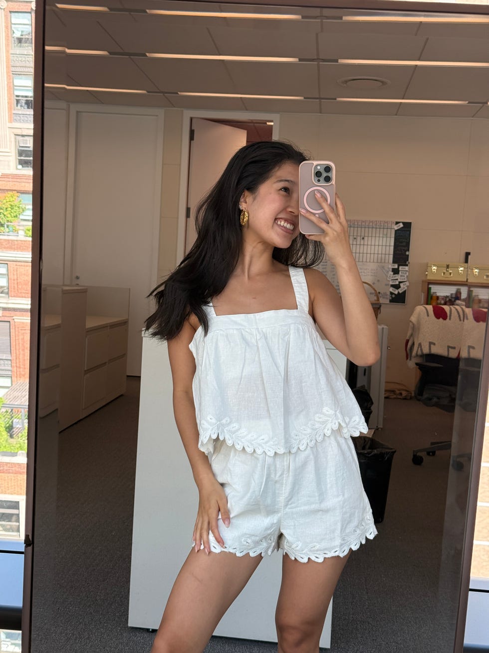 person wearing a white lace top and shorts set
