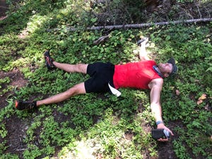 ryan hall lying on the ground around mile 27 of the grand traverse mountain run