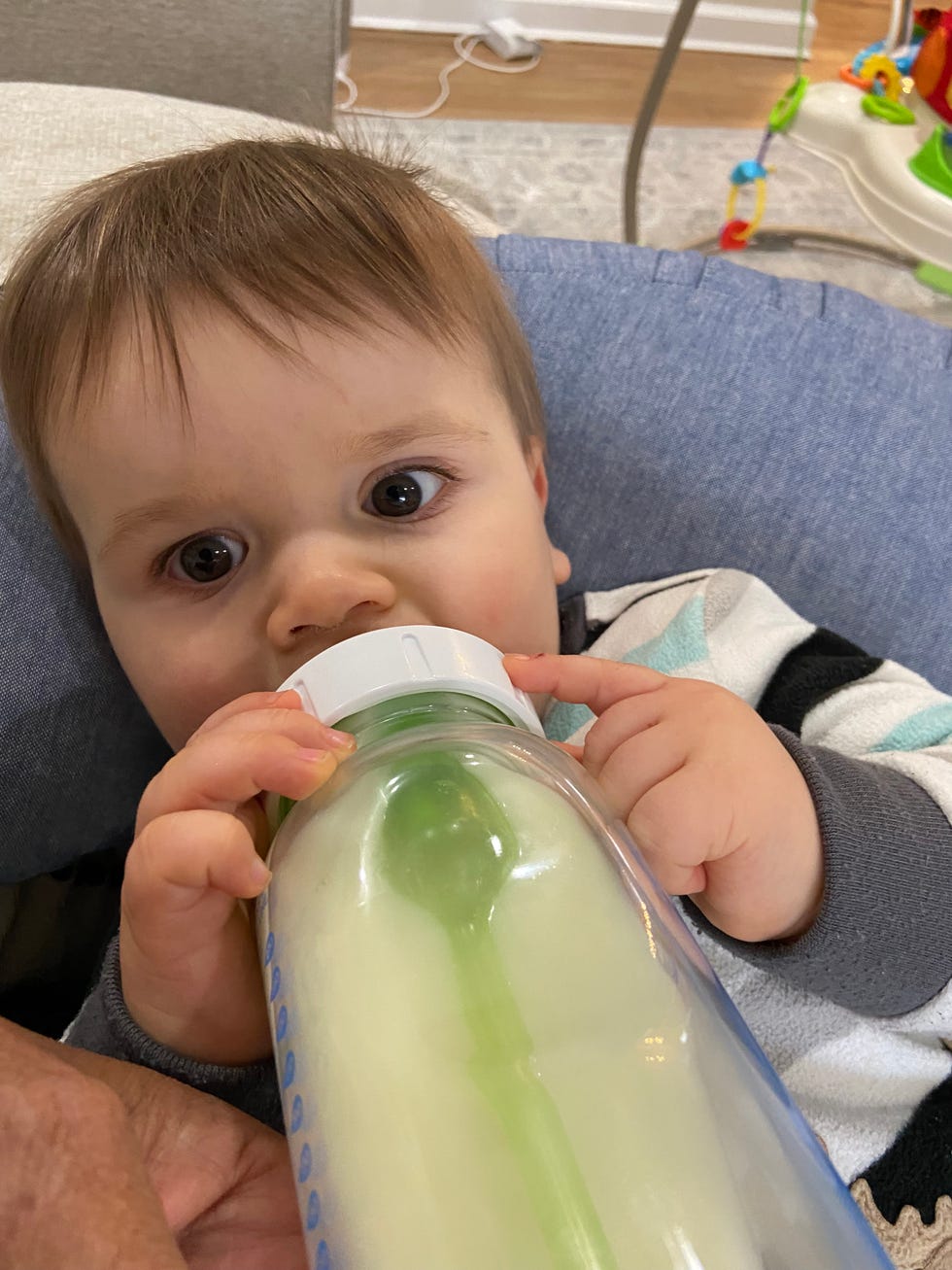 sassos son having a bottle of breastmilk