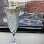 french 75 in a champagne flute with a lemon twist