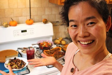 june stands in front of her thanksgiving feast spread