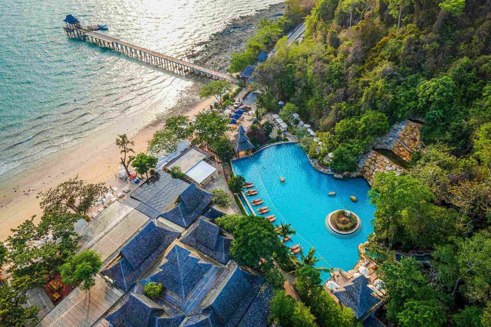 serene resort area featuring a pool beach and pier serene resort area featuring a pool beach and pier