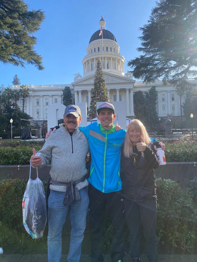riley cook after the california international marathon with his parents