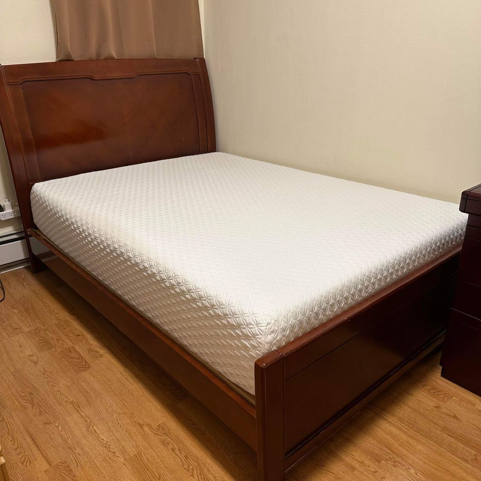 the nolah original 10 mattress on a wooden bed frame in the home of a consumer tester