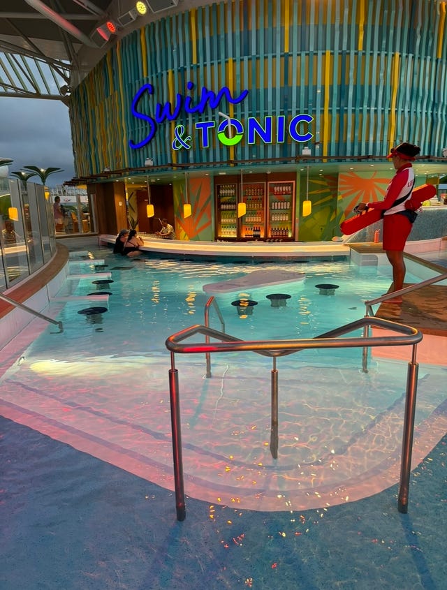 a pool with a person standing in the background