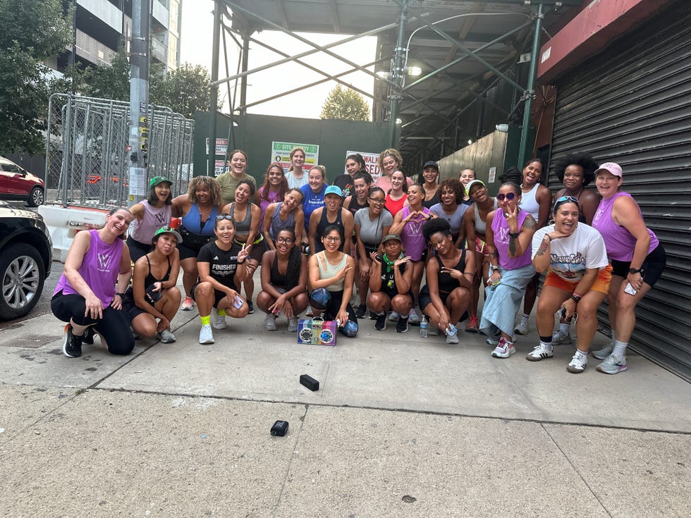 group of individuals posing together outdoors in athletic clothing