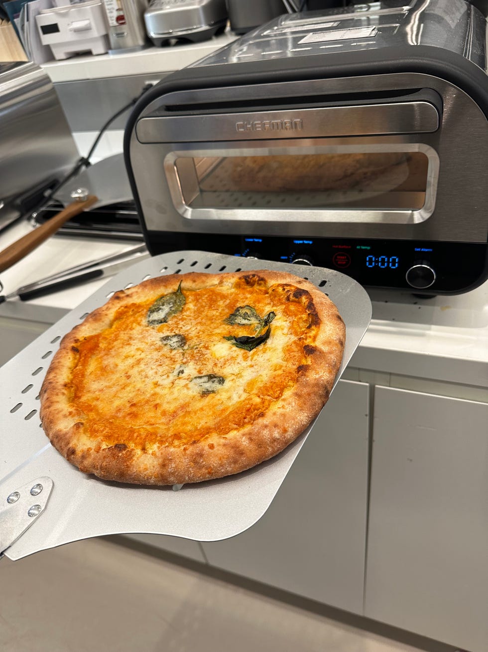 a baked pie on a pizza peel near pizza oven
