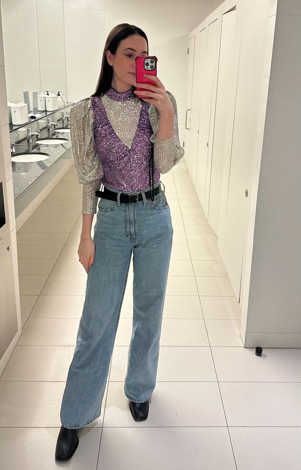 a woman taking a selfie in a bathroom with a rotate sequin top from rent the runway, good housekeeping's rent the runway review