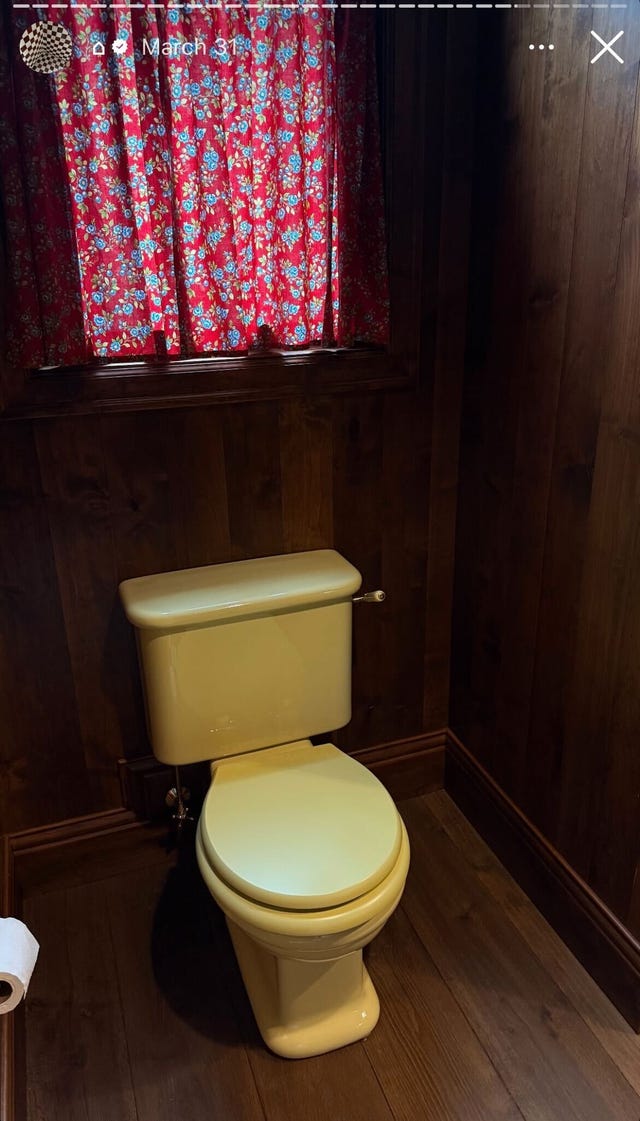 wood paneled bathroom with butter yellow toilet