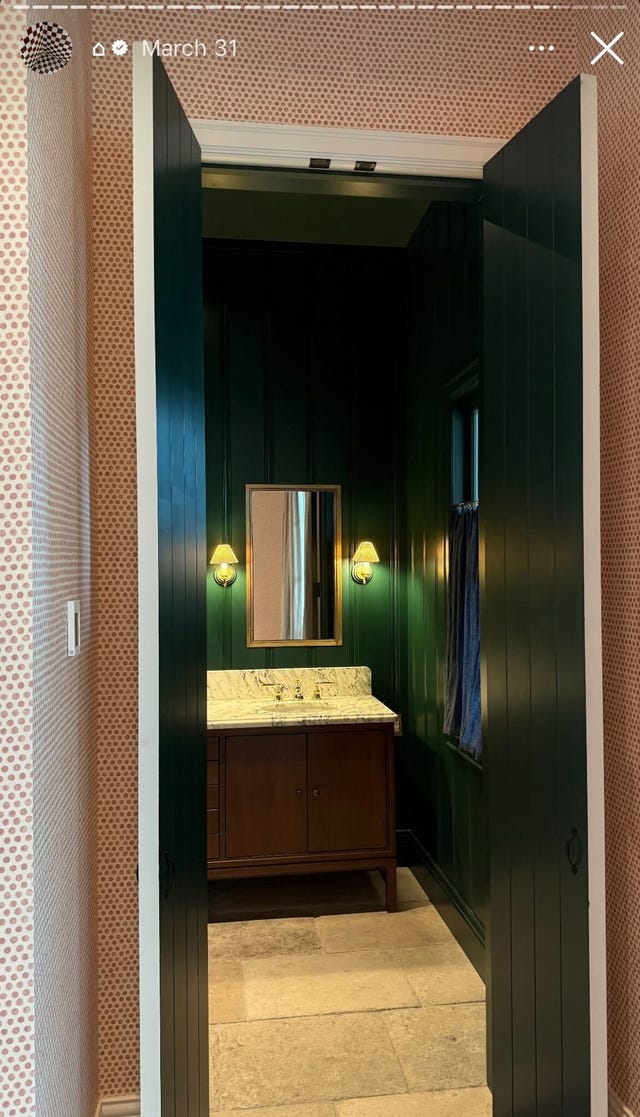 bathroom with green walls and a wood vanity