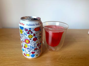poppi fruit punch flavor in a can and glass side by side