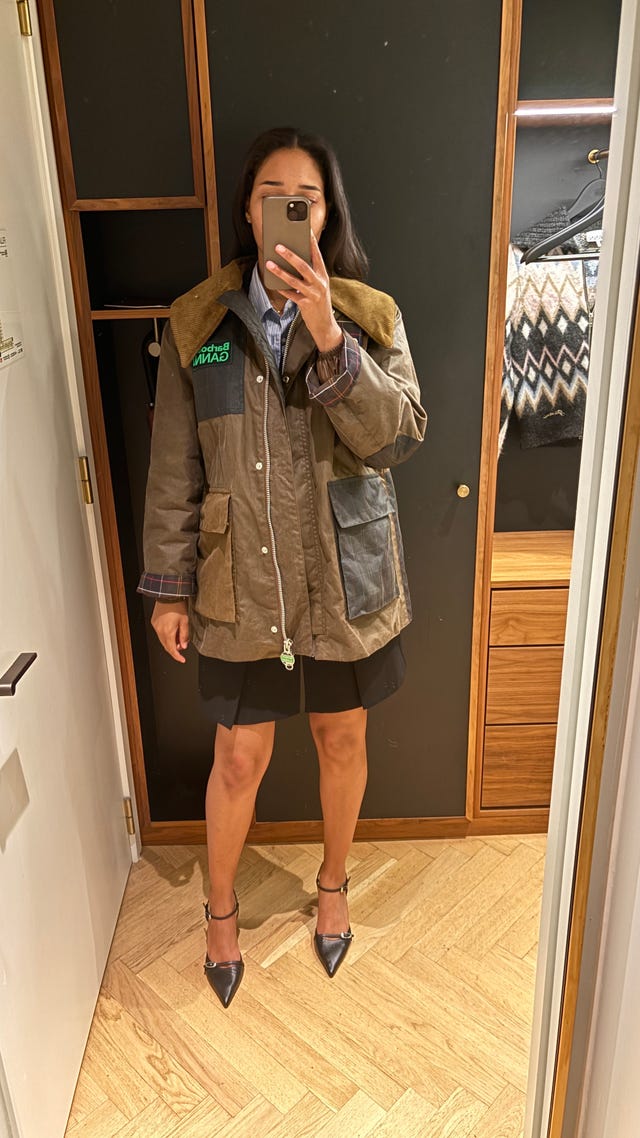 a man in a stylish casual outfit: a brown jacket with patches and high-heeled shoes.