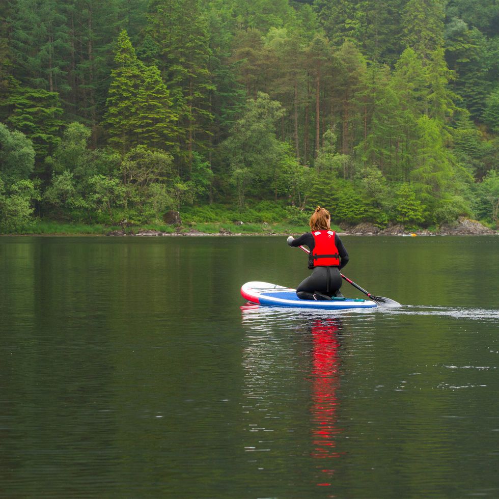 woman paddleboarding in lake chon