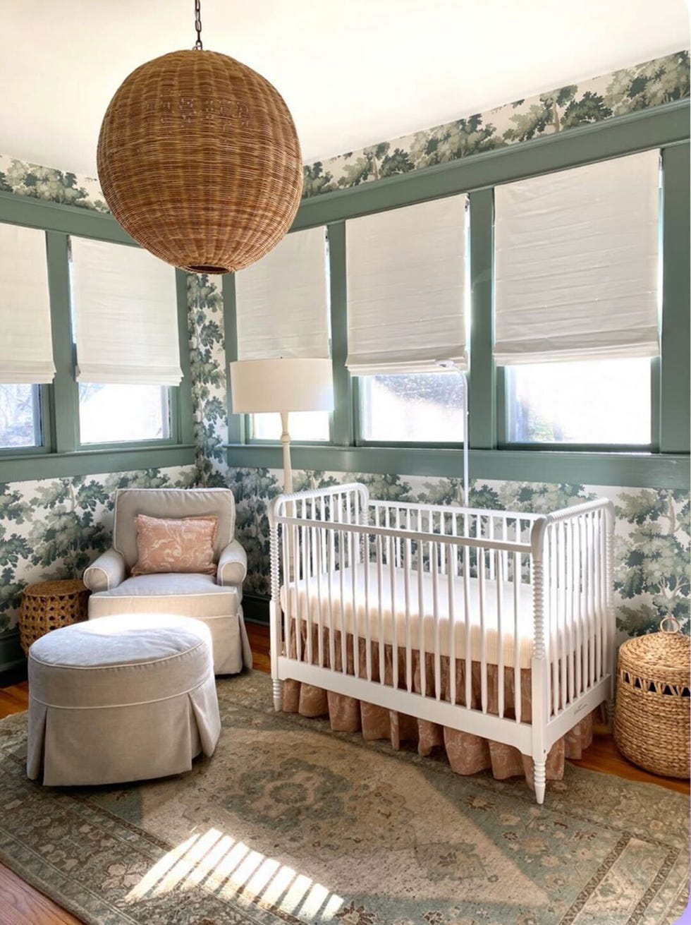 a nursery with green wallpaper