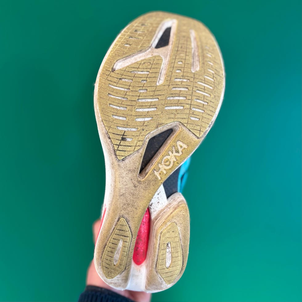 bottom view of a running shoe showcasing its sole design and wear