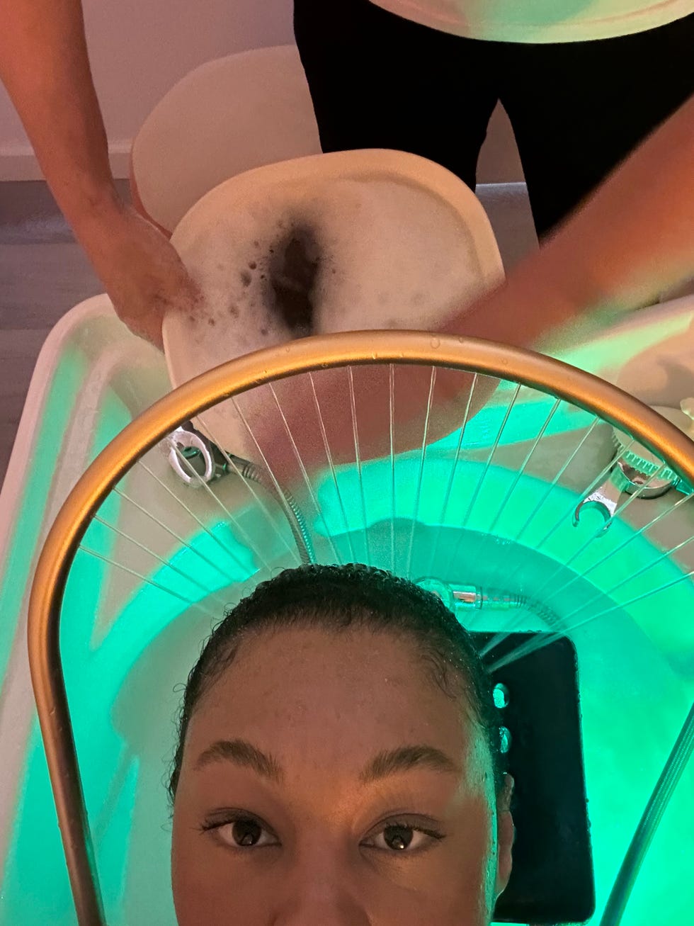 a woman getting her hair rinsed