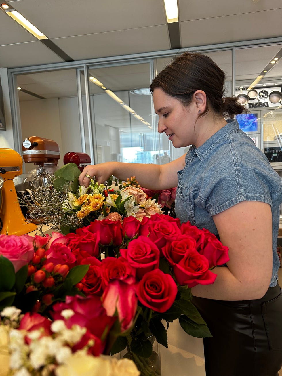 woman inspecting flowers