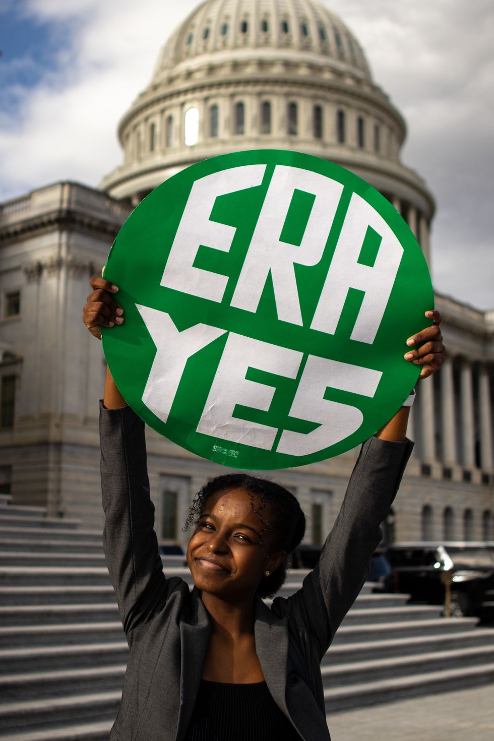 an organizer holding a sign that reads era yes