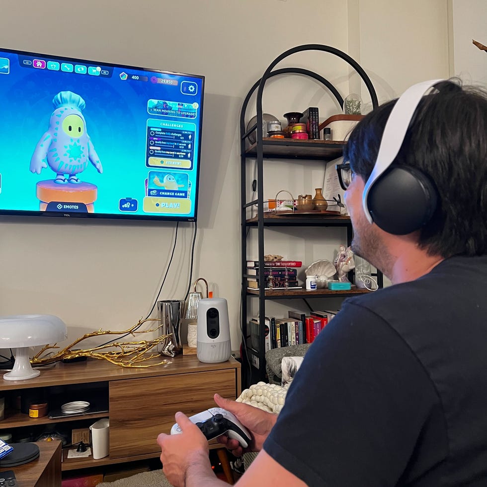 a man wearing the playstation pulse 3d headphones and playing fall guys a man wearing the playstation pulse 3d headphones and playing fall guys