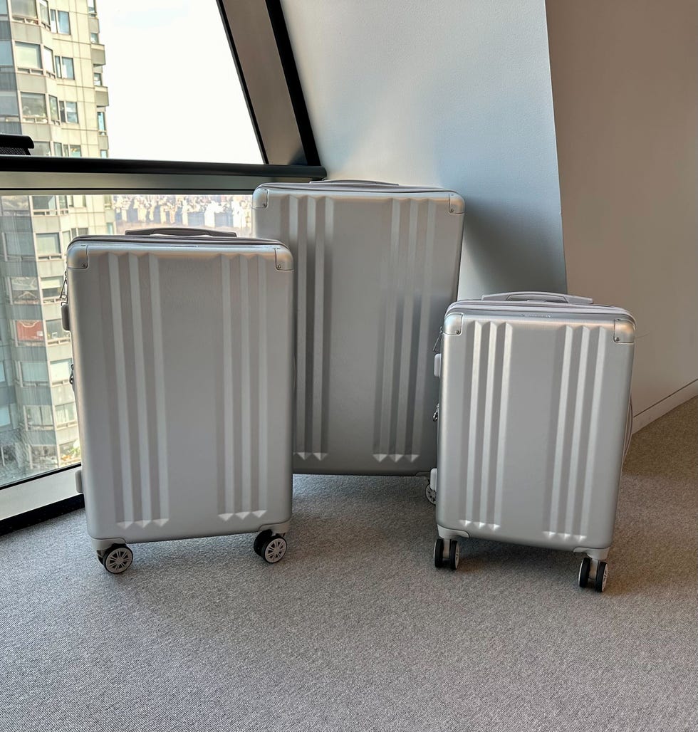 three silver suitcases from calpak