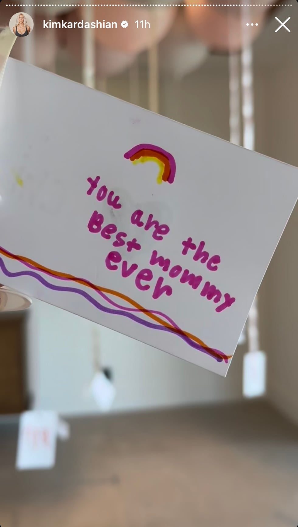 A handmade card features the message “You are the best mom ever” in pink with a small rainbow illustration above it