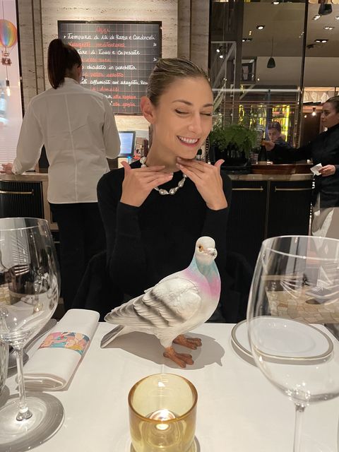 jenny walton with a jw anderson pigeon clutch at a dinner in milan