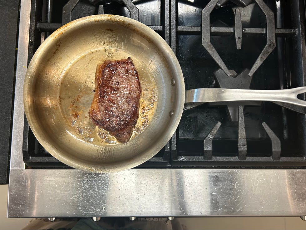 steak in a stainless steel pan