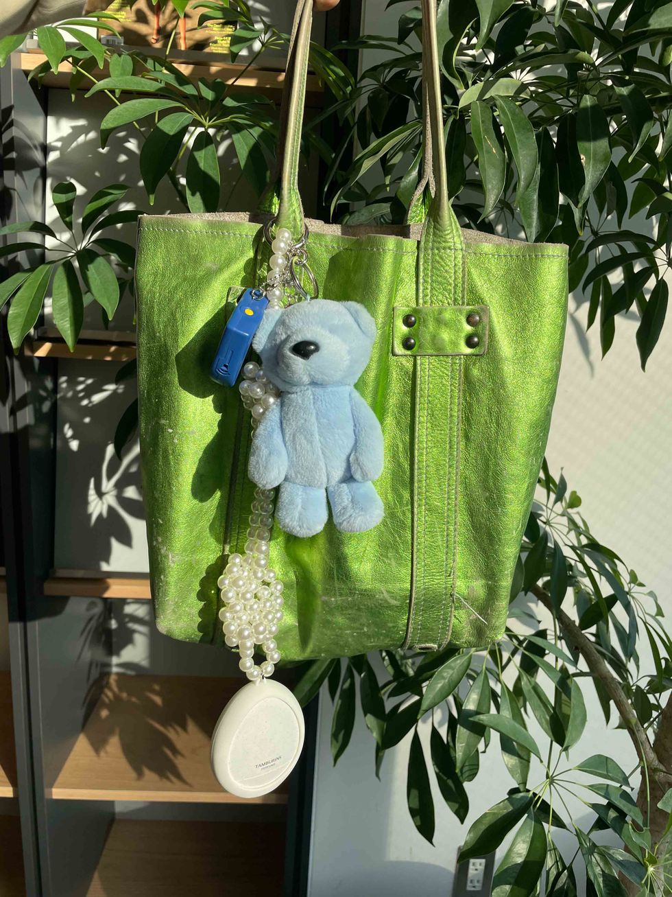 a stuffed bear from a green tree