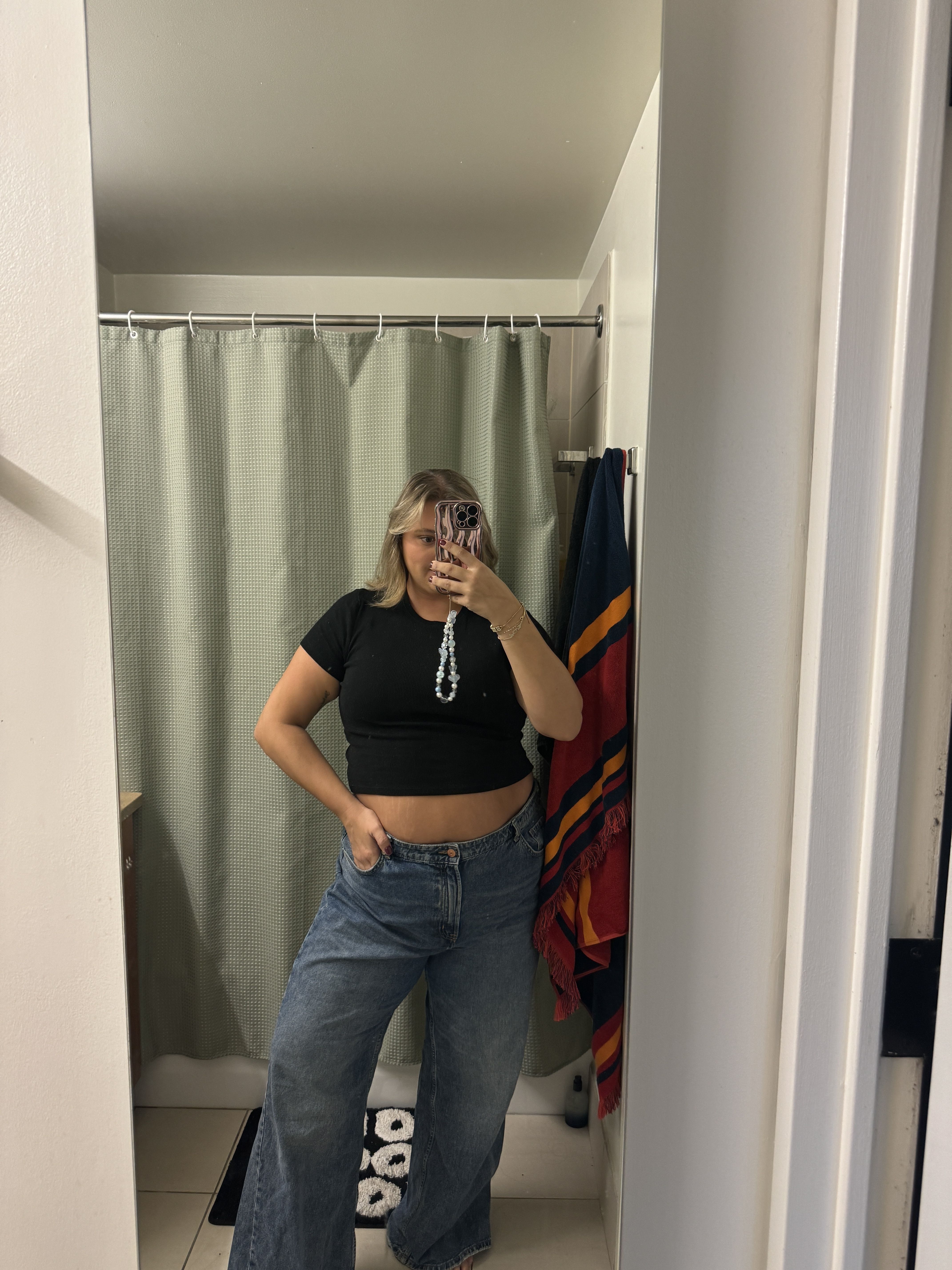 selfie in a bathroom mirror showcasing an outfit