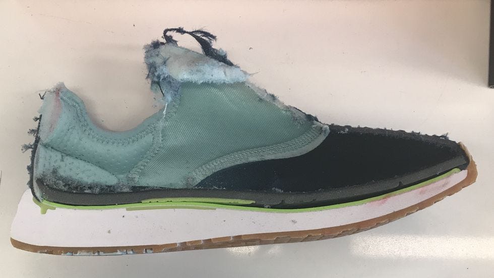 a blue sneaker cut in half on a white table for good housekeeping testing for the best workout shoes