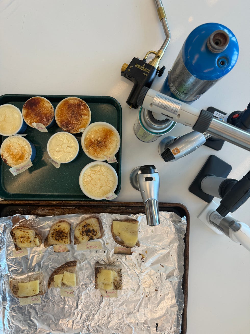 kitchen torches on a counter with creme brulee and grilled cheese