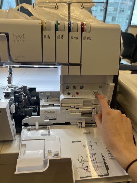 a gh analyst is threading a serger machine to rate how easy it is to thread as part of testing to find the best sergers