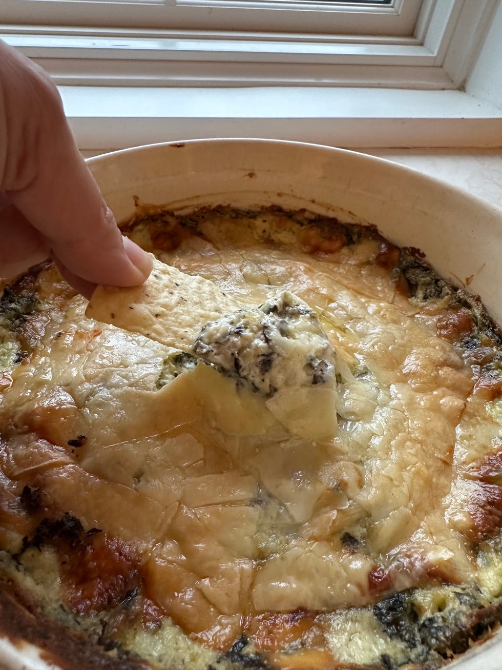 a hand holding a piece of food