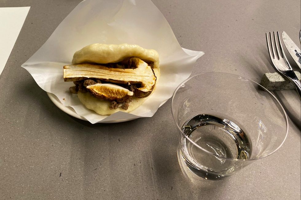 a sandwich and a glass of water on a table