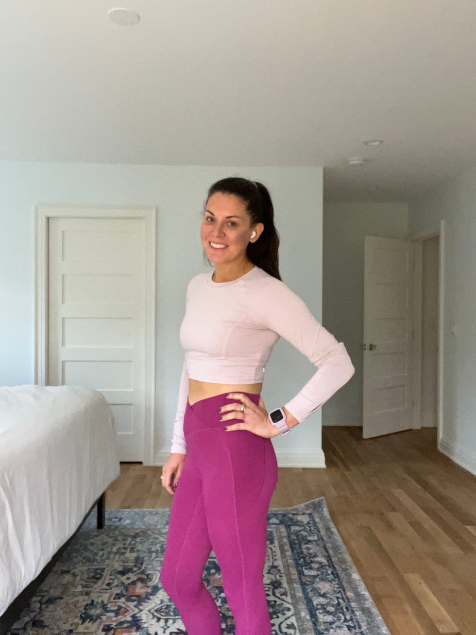 a person standing in a room wearing activewear showcasing a workout outfit