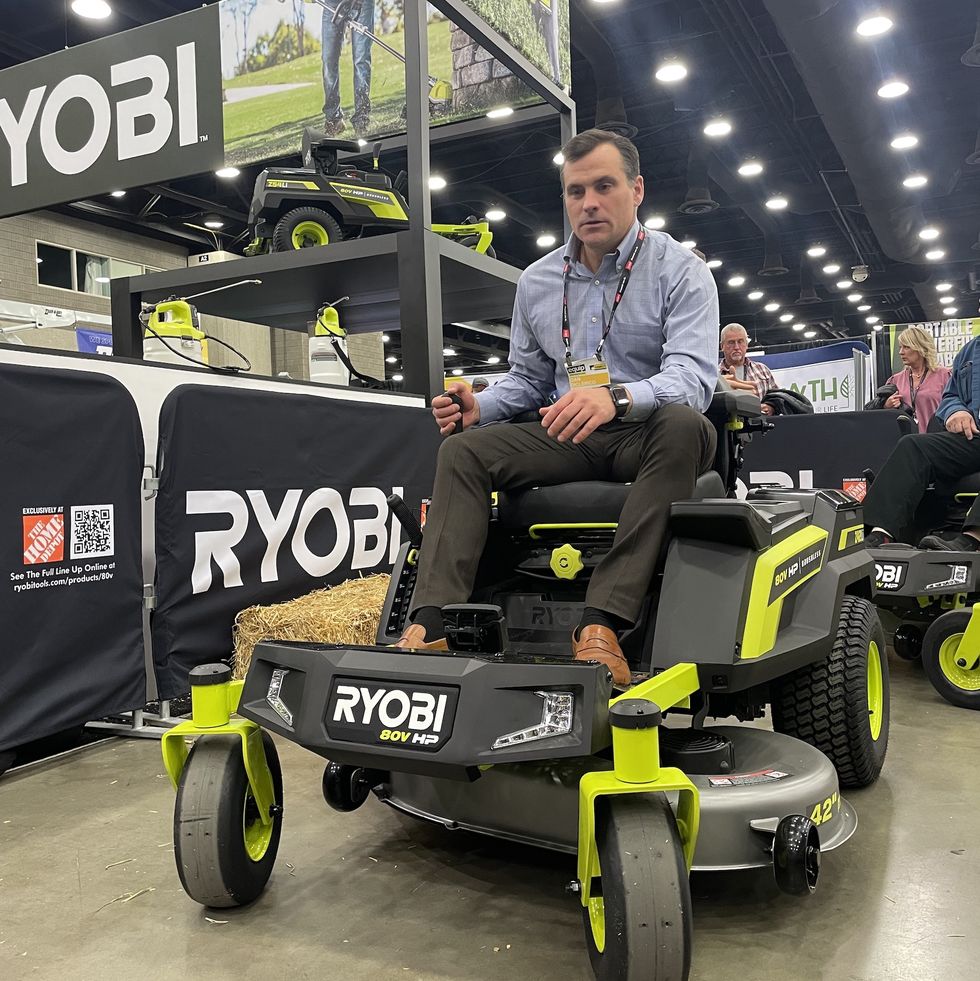 an expert tests a zero turn riding mower at a trade show