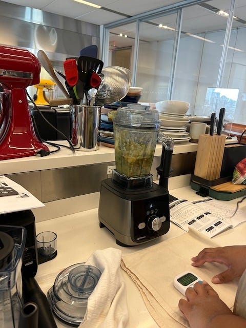 broccoli leek soup blending in blender with hand on timer