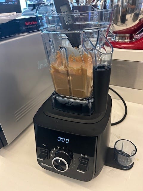 peanut butter inside vitamix blender with thermometer taking temperature