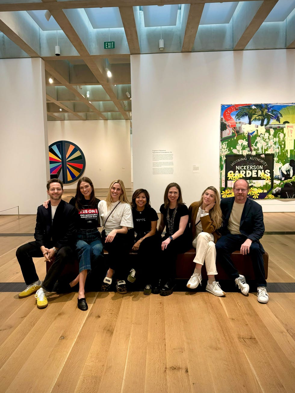 group of people sitting in an art gallery