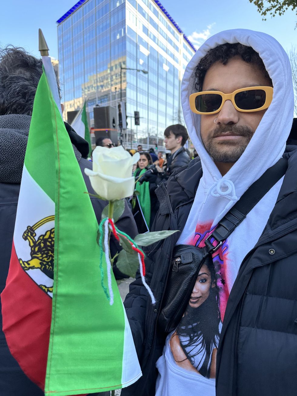 man at protest with iranian flag